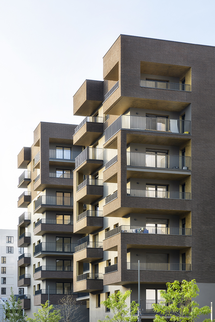 Détail d'un immeuble de logements marron avec détails dorés à Asnières.